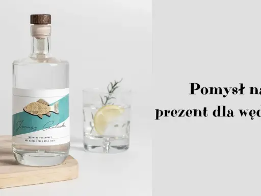 Elegancka butelka z etykietą "Janusz Galicki" i złotą rybką. Idealny pomysł na prezent dla wędkarza, by każda rybka była złota.